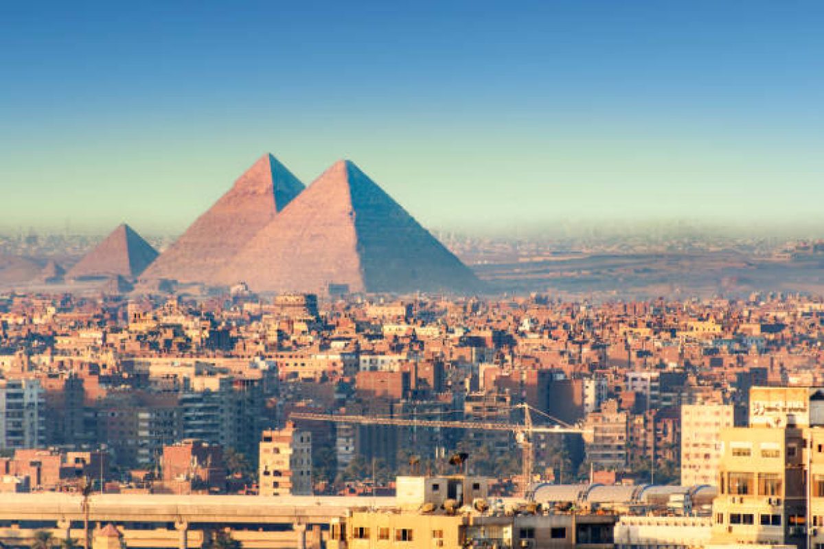 Panoramic view over the city of Cairo with the Great Pyramids in the background